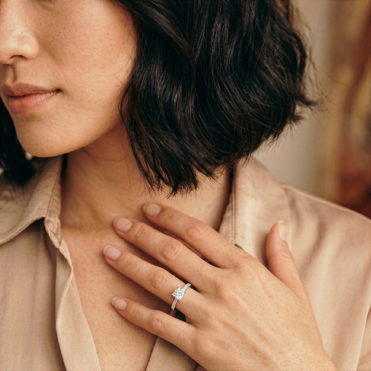 Cushion-Cut Diamond Engagement Ring with Scalloped Band in white gold, worn on the hand