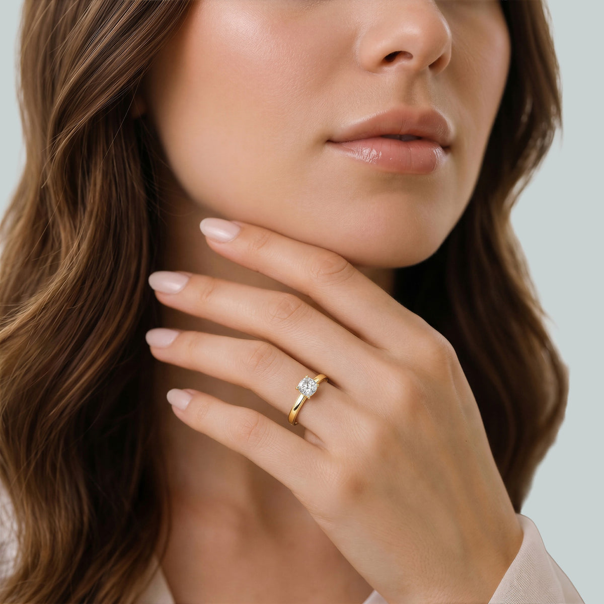 Cushion-Cut Diamond Engagement Ring with Cathedral High Setting in yellow gold, worn on the hand